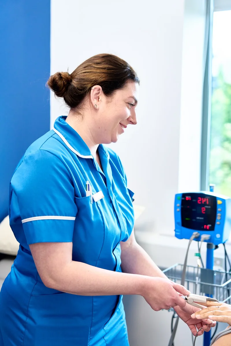 A British Face Clinic nurse checking a patient's observations
